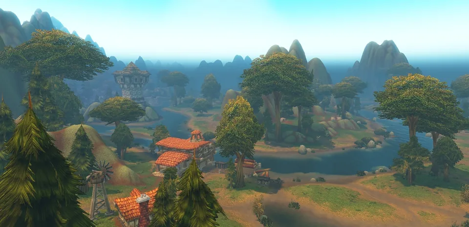 A green valley with a river, red-roofed buildings, a tower and rocky hills