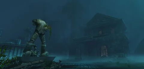 A statue and a dark building in blue fog